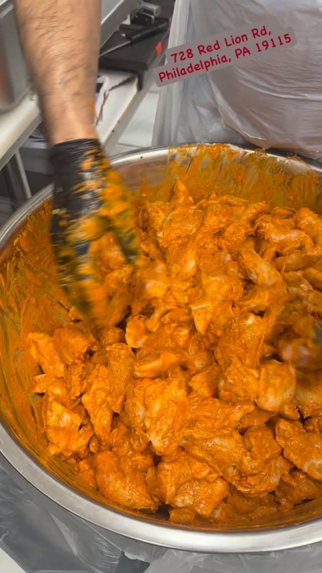 Reel: marinated meat prepared in a large kazan.